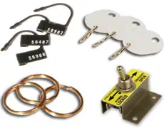 A collection of security hardware items for the Liberty Township Volunteer Fire Department, including numbered plastic security seals, three metal key tags, three metal key rings, and a metal keyswitch with a toggle lever and label.